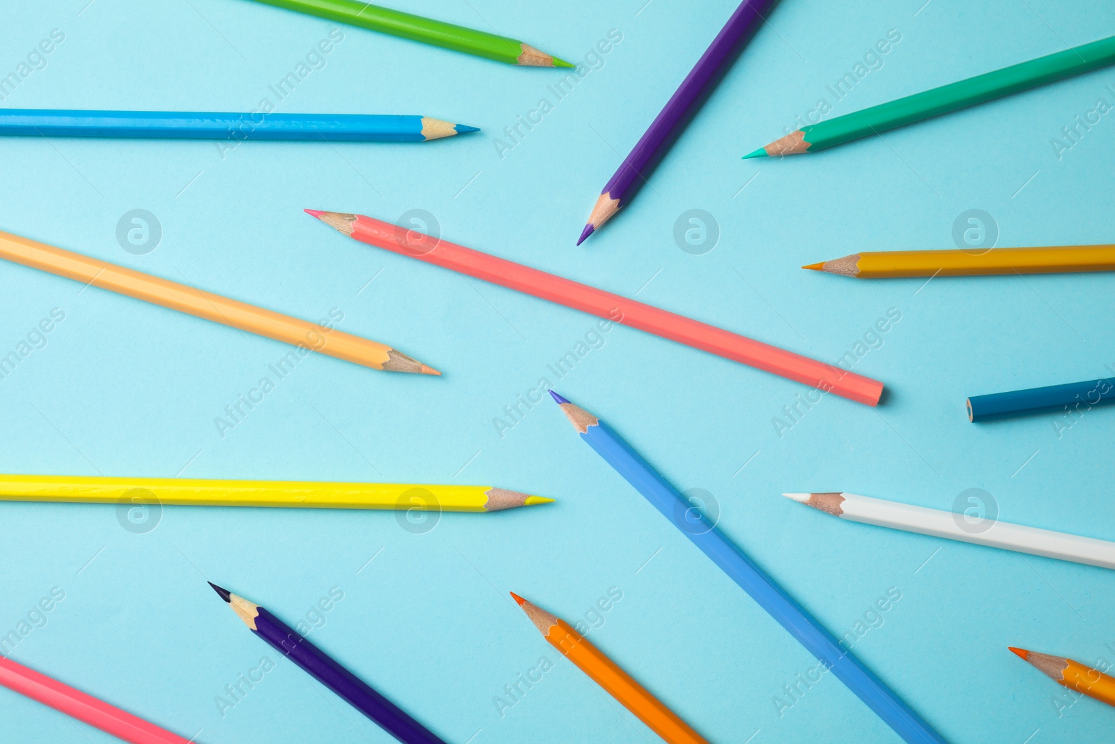 Photo of Composition with color pencils on blue background