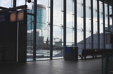 Waiting benches near big glass windows indoors