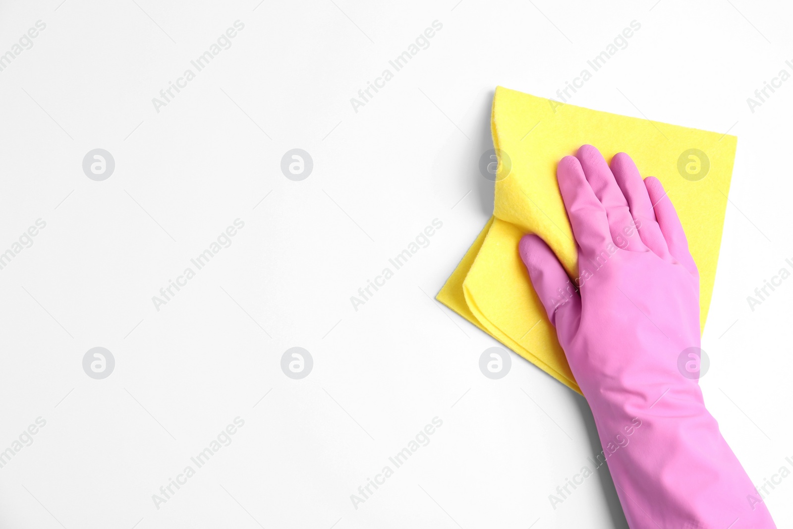 Photo of Person in rubber glove with rag on white background, closeup of hand