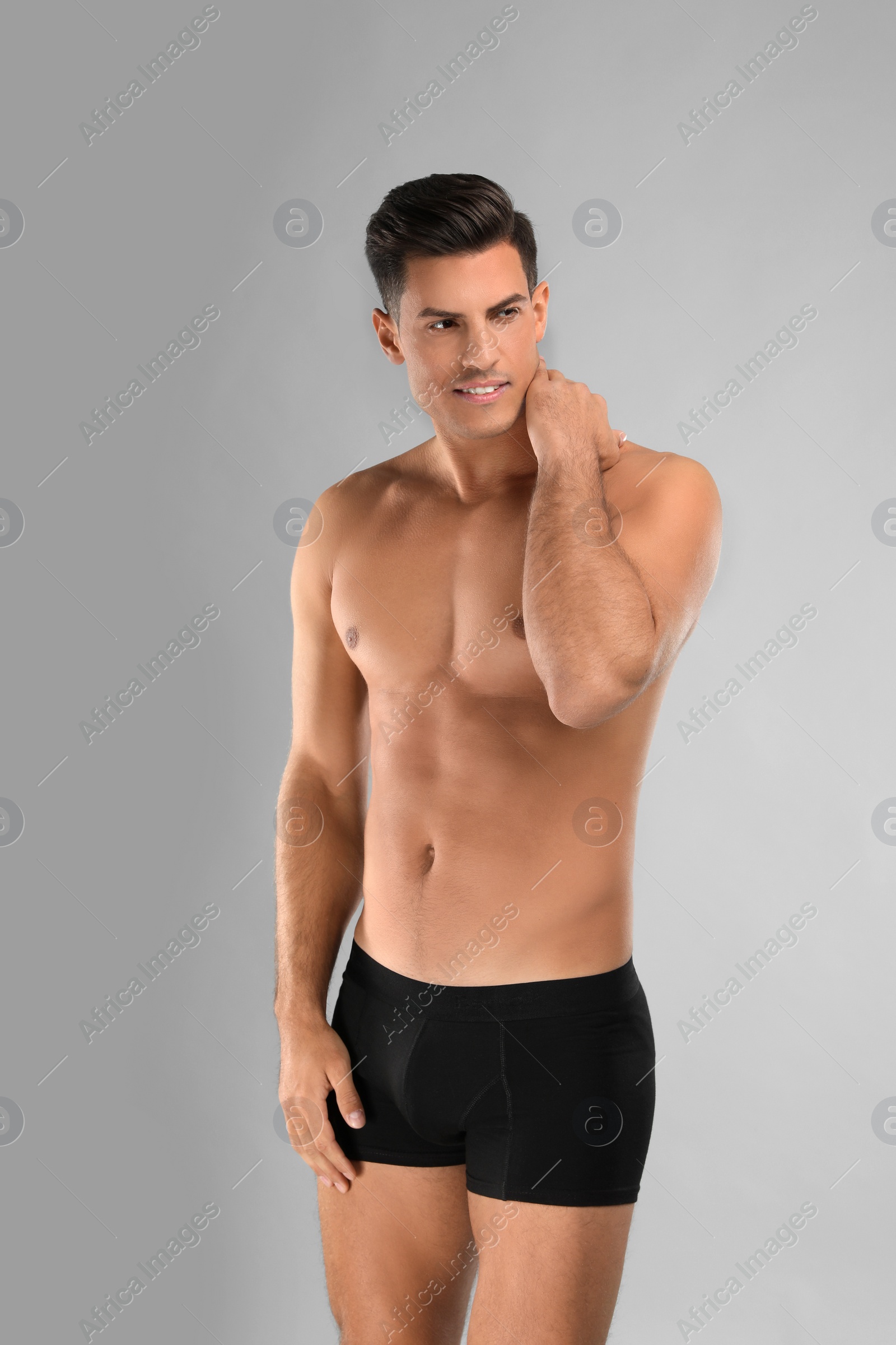 Photo of Handsome man in black underwear on light grey background