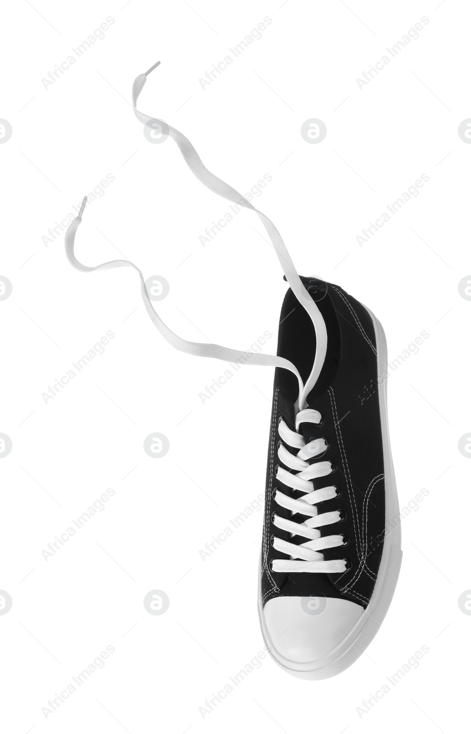 Photo of One black classic old school sneaker isolated on white