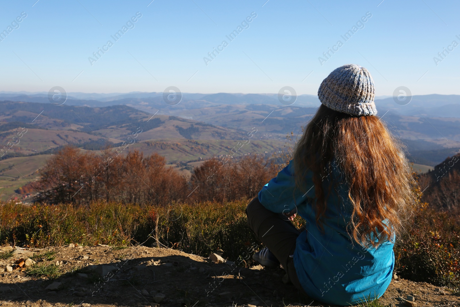 Photo of Woman in warm clothes enjoying mountain landscape