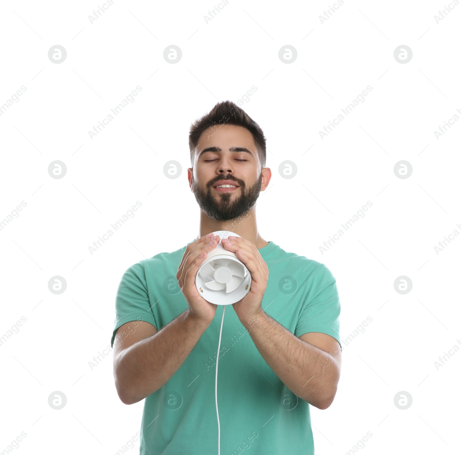 Photo of Man enjoying air flow from portable fan on white background. Summer heat