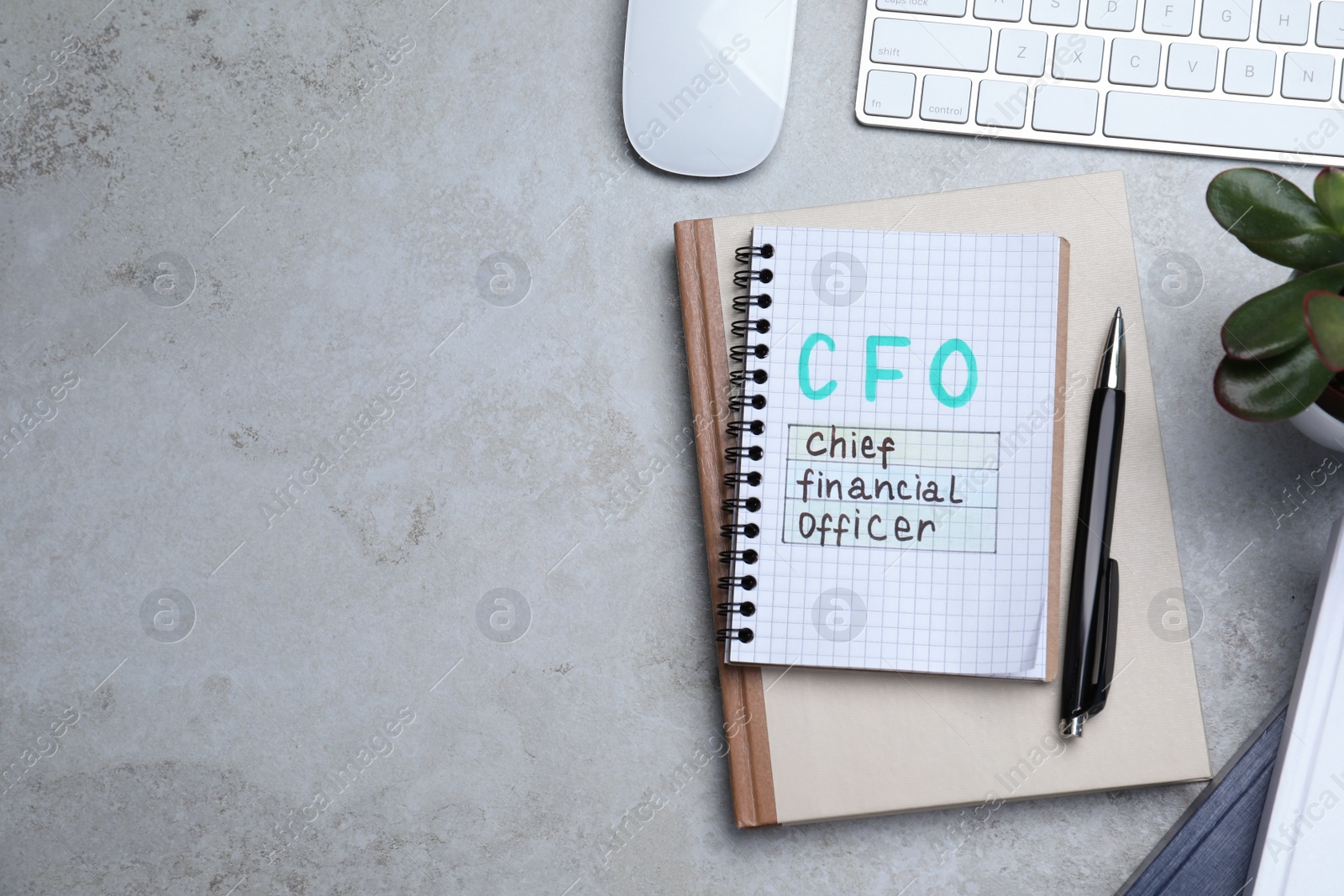 Photo of Notebook with CFO abbreviation and space for text on grey office table, flat lay. Financial management