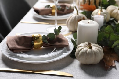 Photo of Beautiful autumn table setting. Plates, cutlery, glasses, pumpkins and floral decor