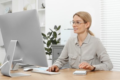 Photo of Professional accountant working at wooden desk in office