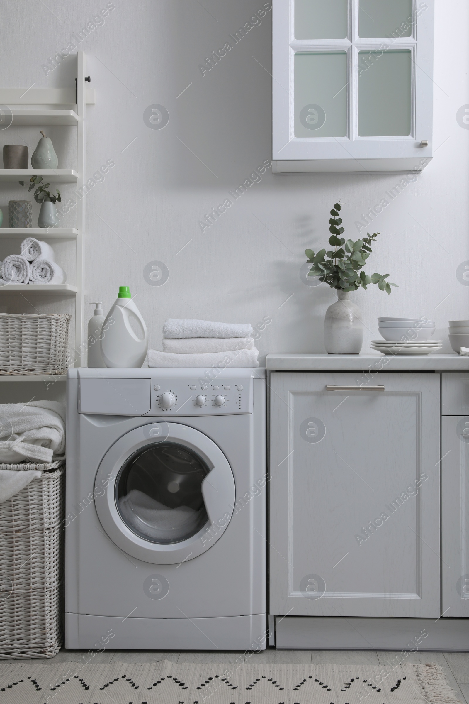 Photo of Kitchen interior with washing machine and stylish furniture