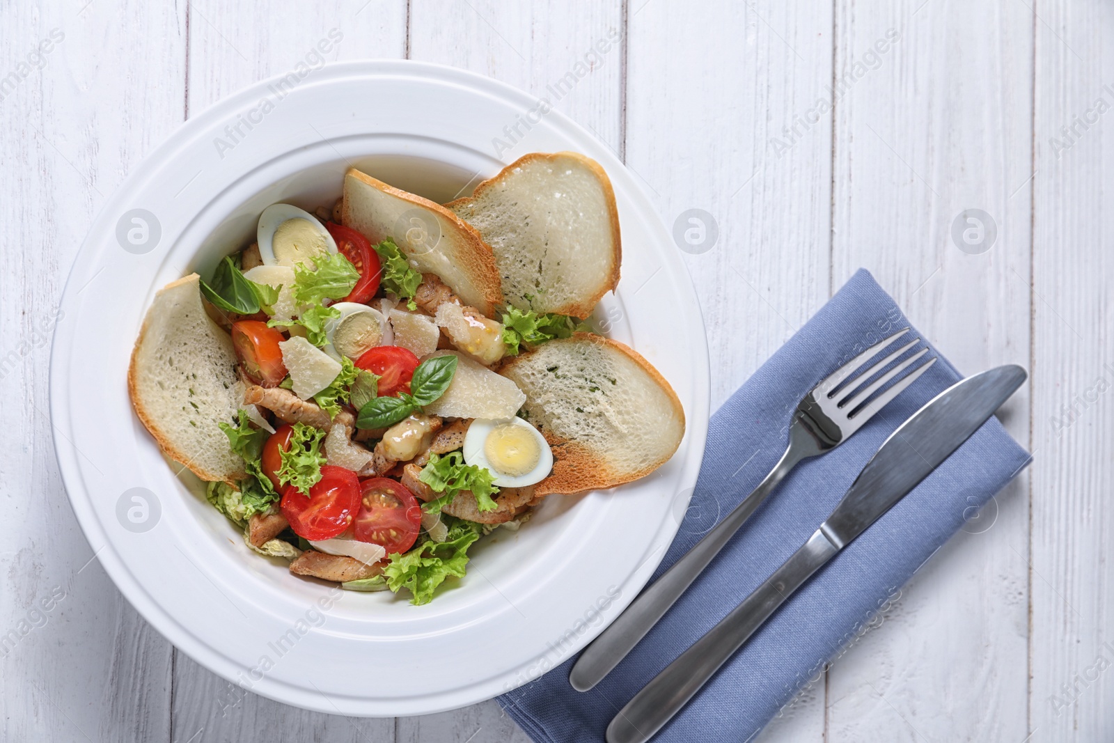 Photo of Plate with delicious fresh salad on table, top view