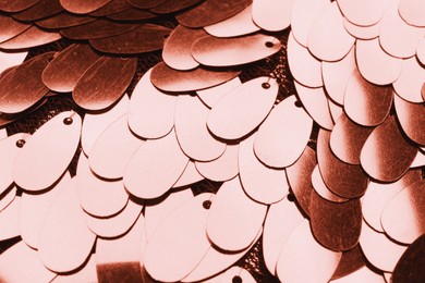 Image of Fabric with rose gold sequins as background, closeup
