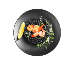 Photo of Delicious black risotto with shrimps and lemon isolated on white, top view
