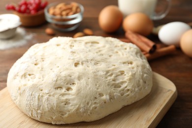 Photo of Board with wheat dough for pastries, closeup