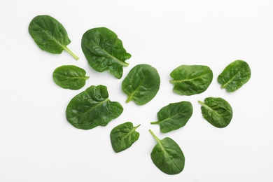 Photo of Fresh leaves of spinach isolated on white, top view