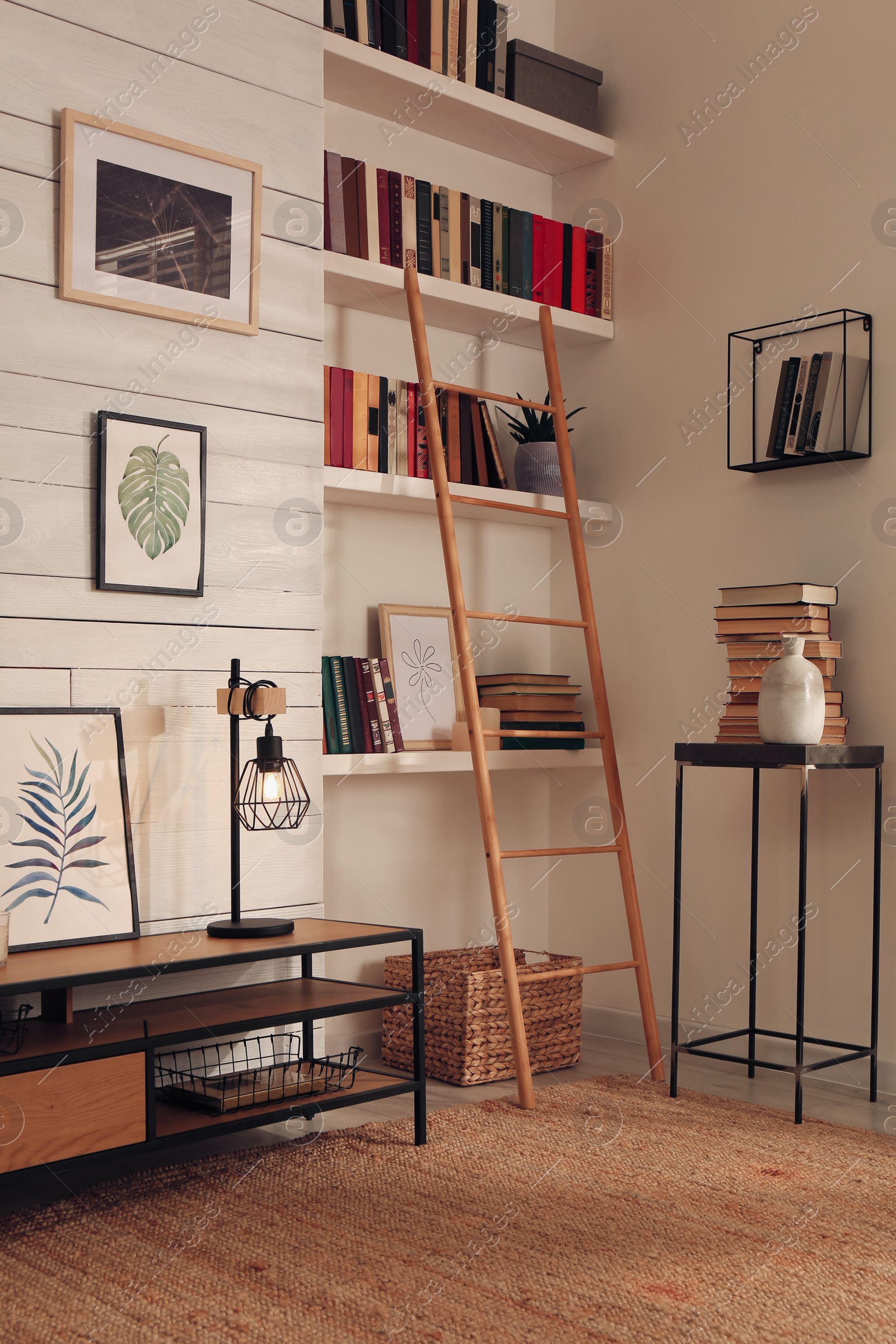 Photo of Home library interior with modern furniture and collection of different books on shelves