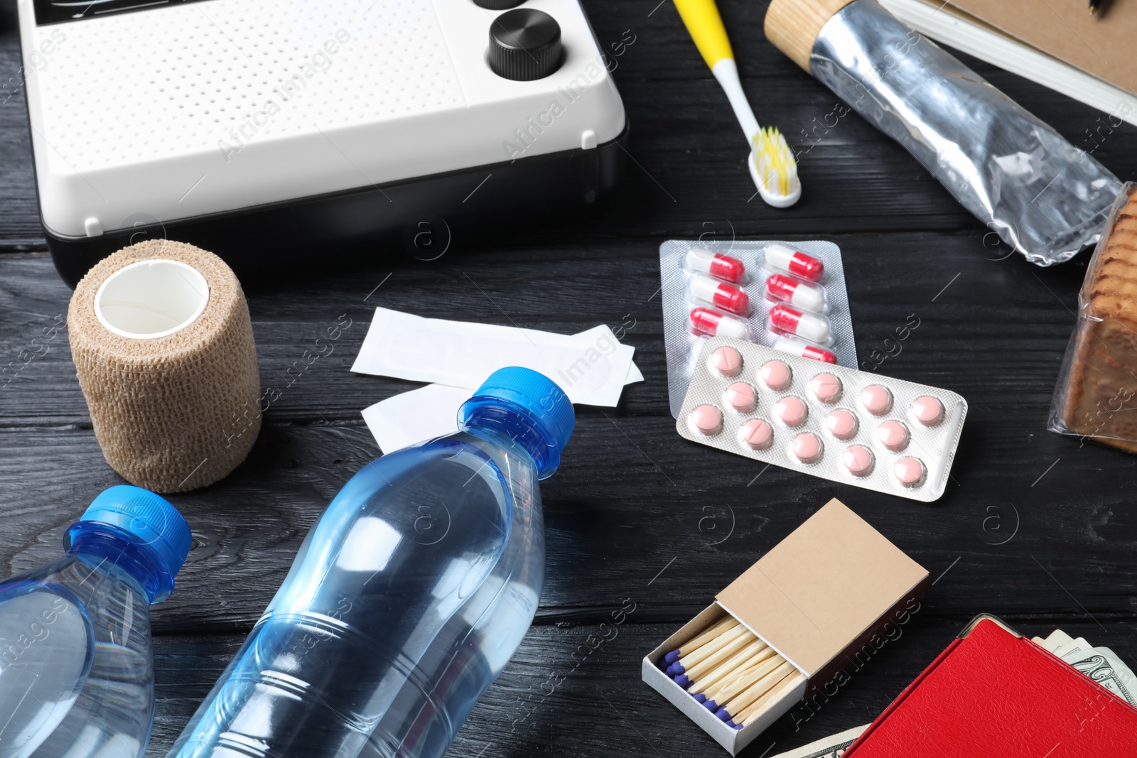 Photo of Disaster supply kit for earthquake on black wooden table