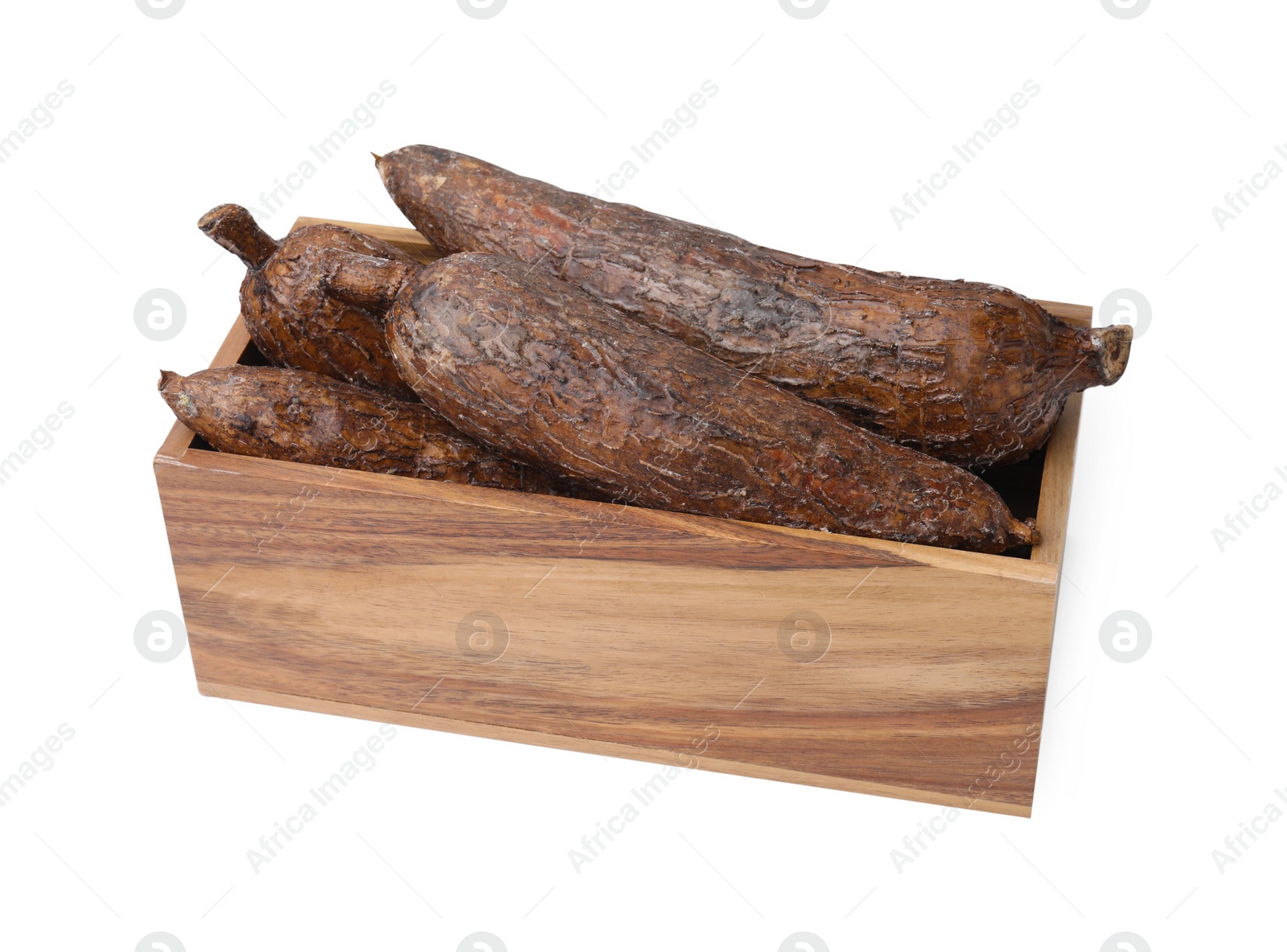 Photo of Whole cassava roots in wooden crate isolated on white