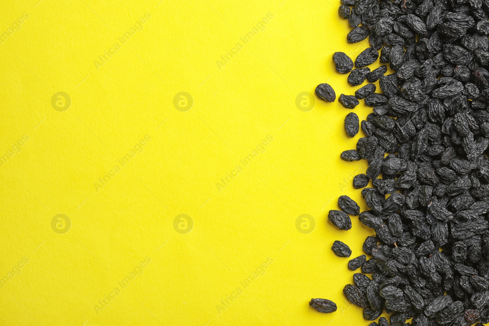 Photo of Yummy raisins on color background, top view with space for text. Dried fruit as healthy snack