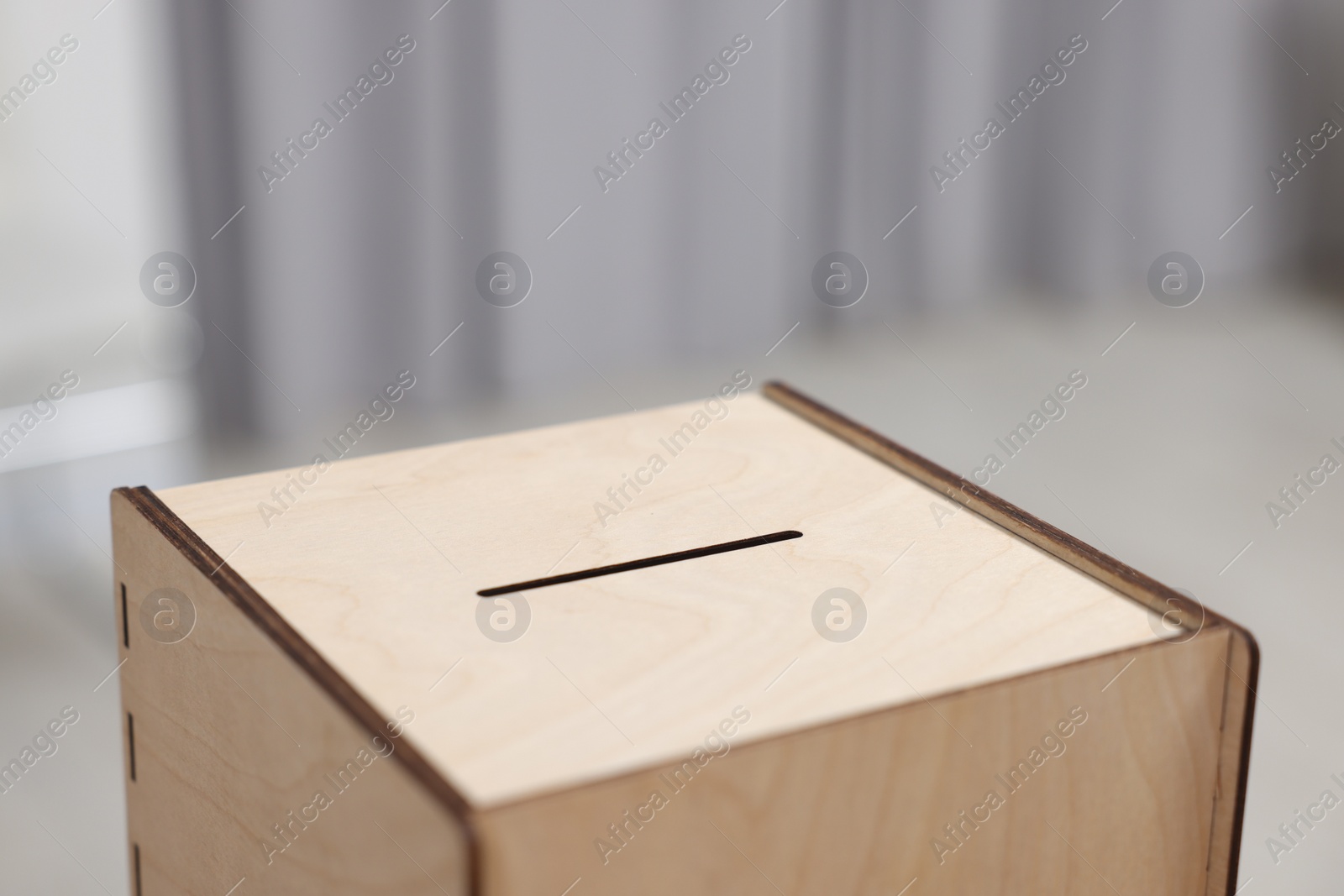 Photo of Wooden ballot box on blurred background, closeup