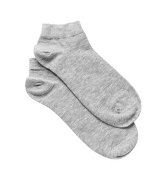 Photo of Pair of grey socks on white background, top view
