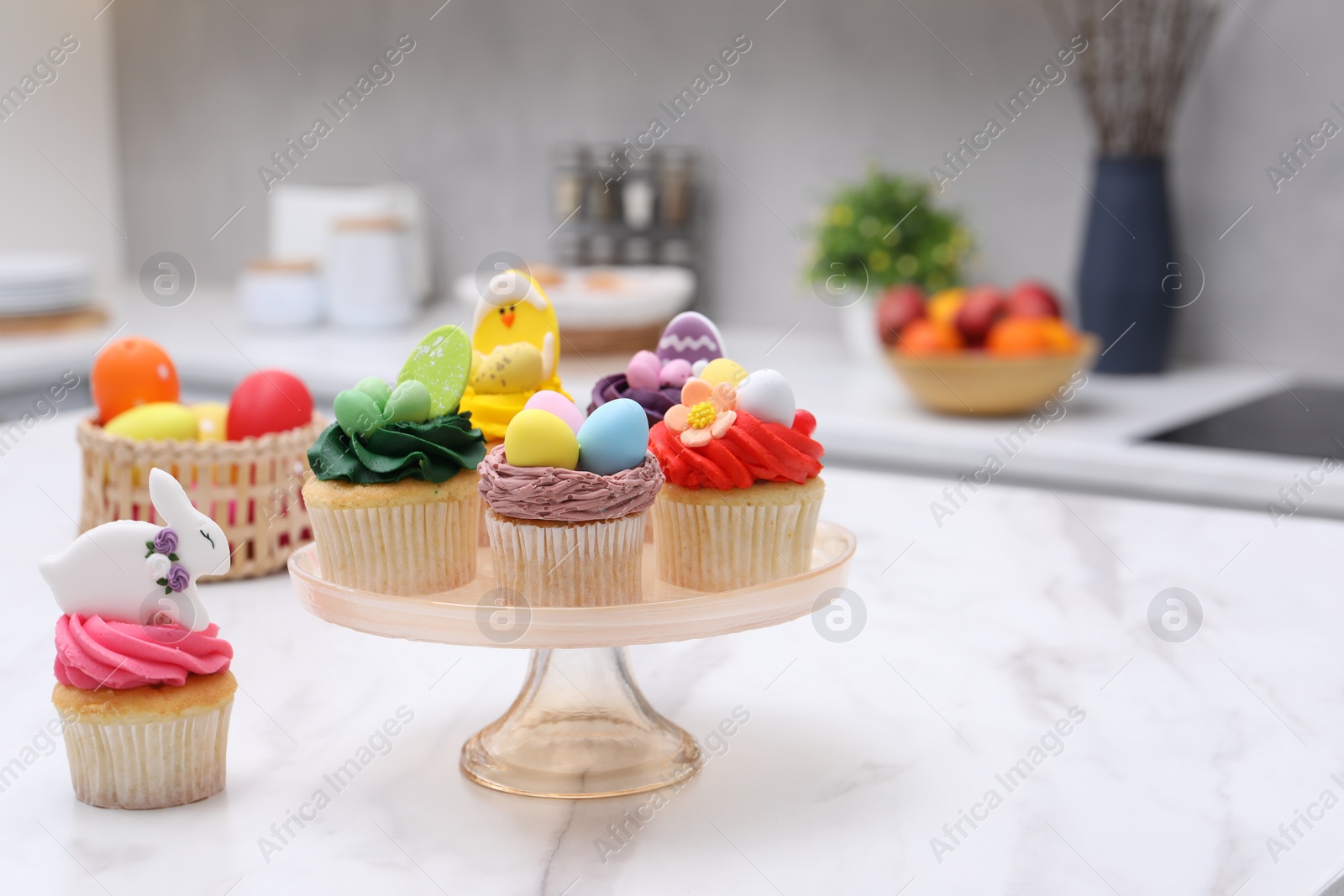 Photo of Tasty decorated Easter cupcakes on white marble table, space for text