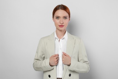 Photo of Portrait of beautiful young woman on light gray background