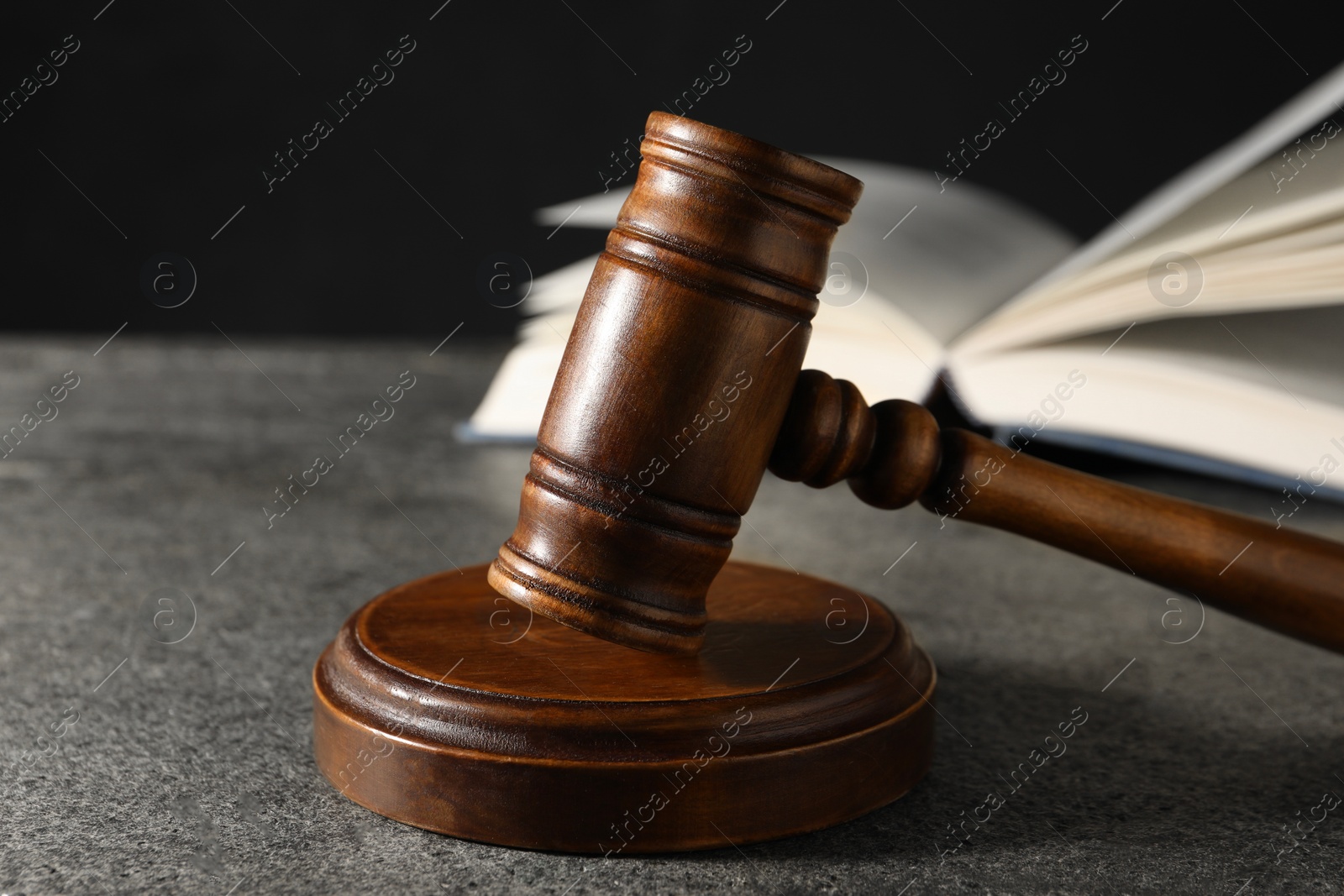 Photo of Law concept. Gavel and book on grey textured table, closeup