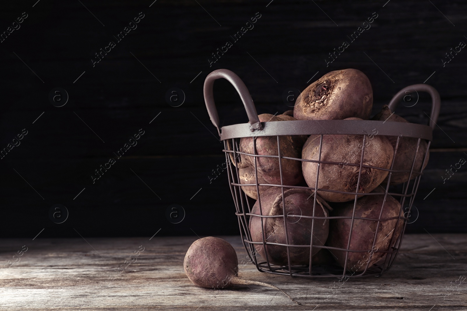 Photo of Basket with whole fresh beets on wooden table