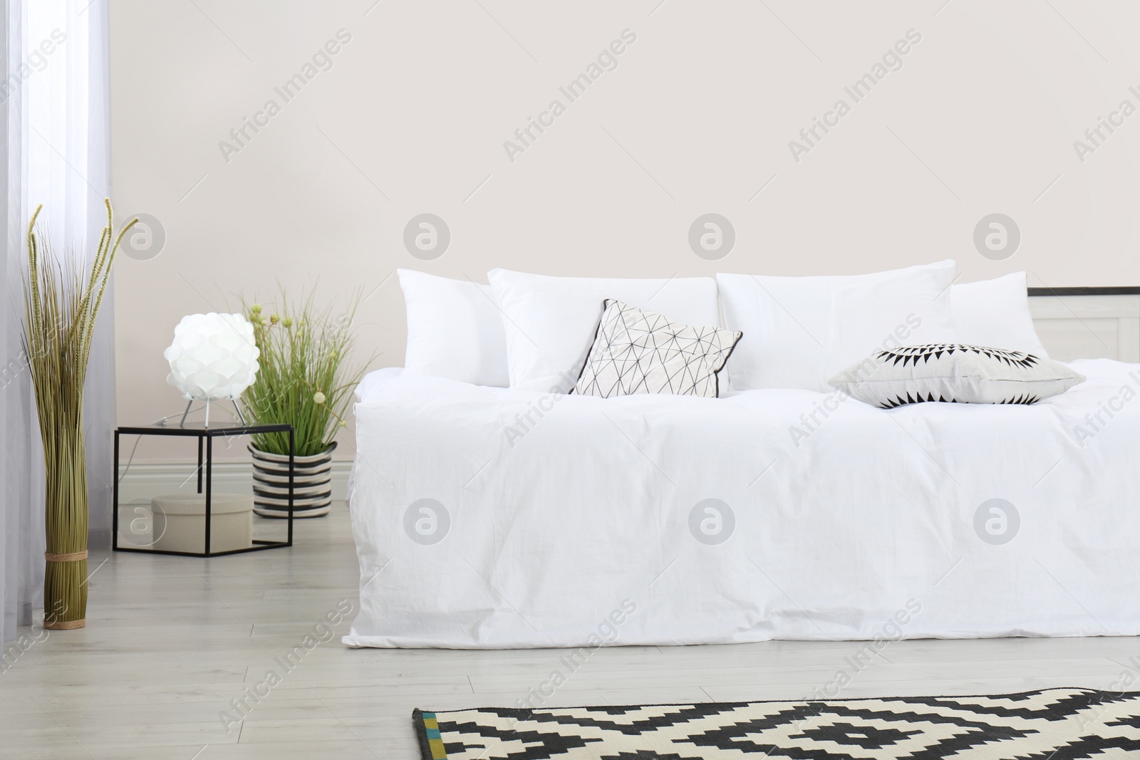 Photo of Simple room interior with large comfortable bed