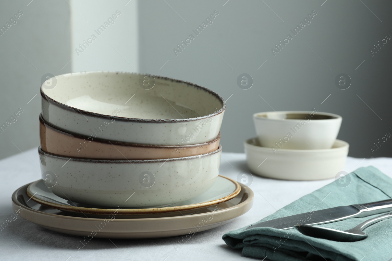 Photo of Stylish empty dishware and cutlery on table, closeup. Space for text