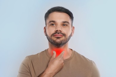 Image of Endocrine system. Man doing thyroid self examination on light grey background