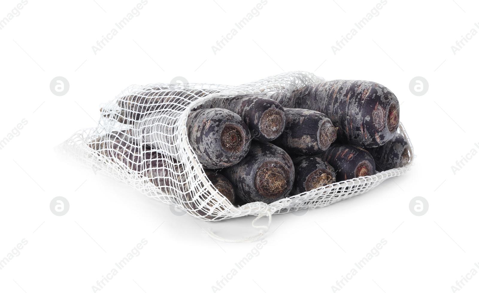 Photo of Raw black carrots in mesh bag isolated on white