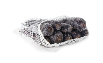 Photo of Raw black carrots in mesh bag isolated on white