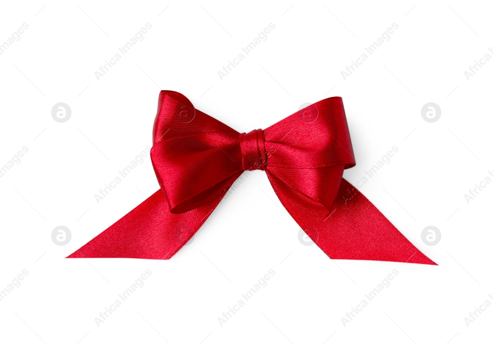 Photo of Red satin ribbon bow on white background, top view
