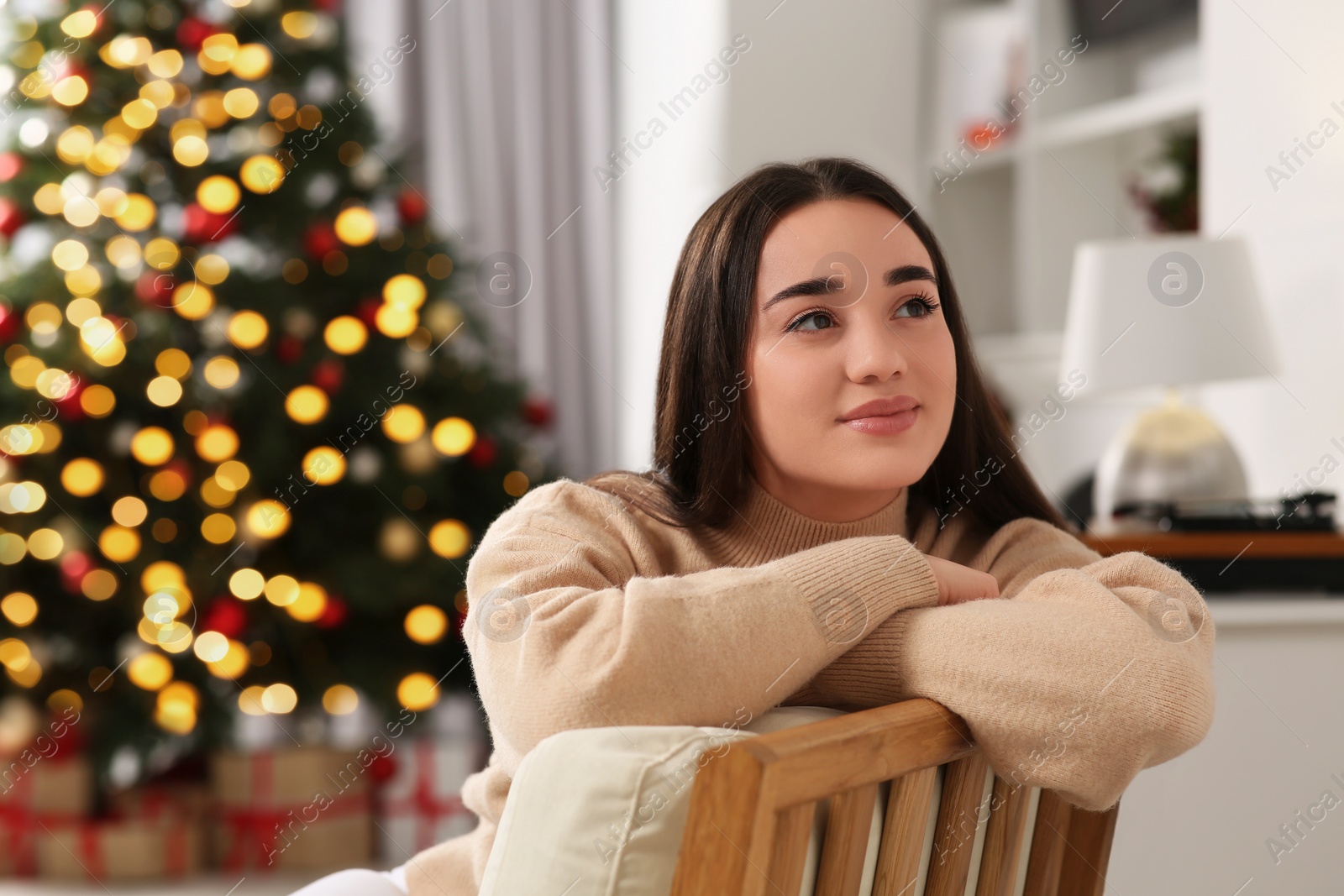 Photo of Christmas mood. Beautiful woman in cosy room. Space for text