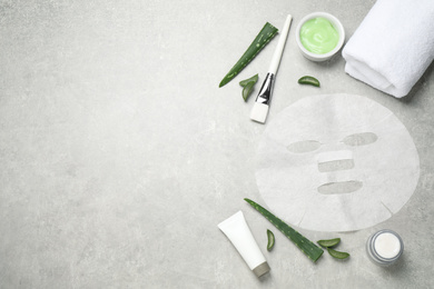 Photo of Flat lay composition with different cosmetic products and aloe on grey table, space for text