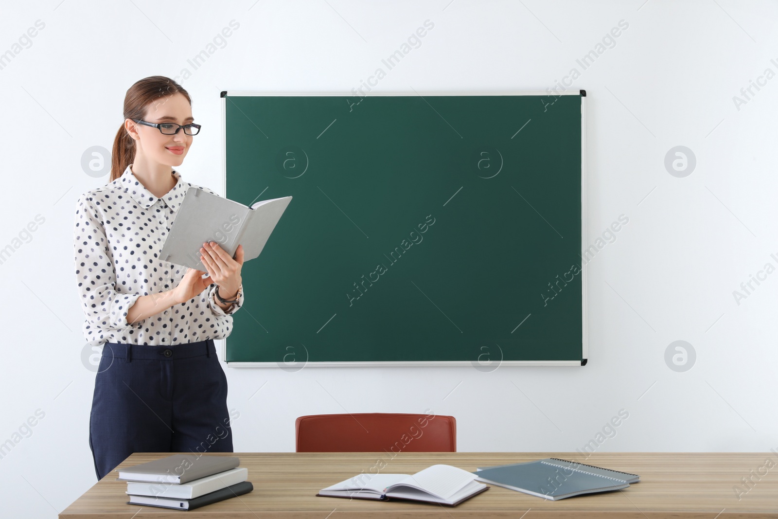 Photo of Portrait of young female teacher in classroom