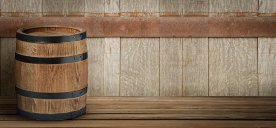 Image of Barrel on wooden background, space for text. Banner design