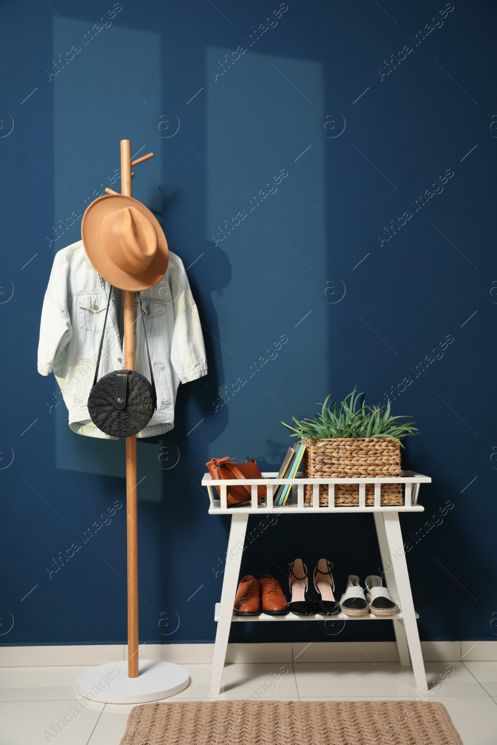 Photo of Hallway interior with stylish furniture, clothes and accessories