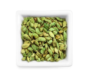 Photo of Dry cardamom pods in bowl isolated on white, top view