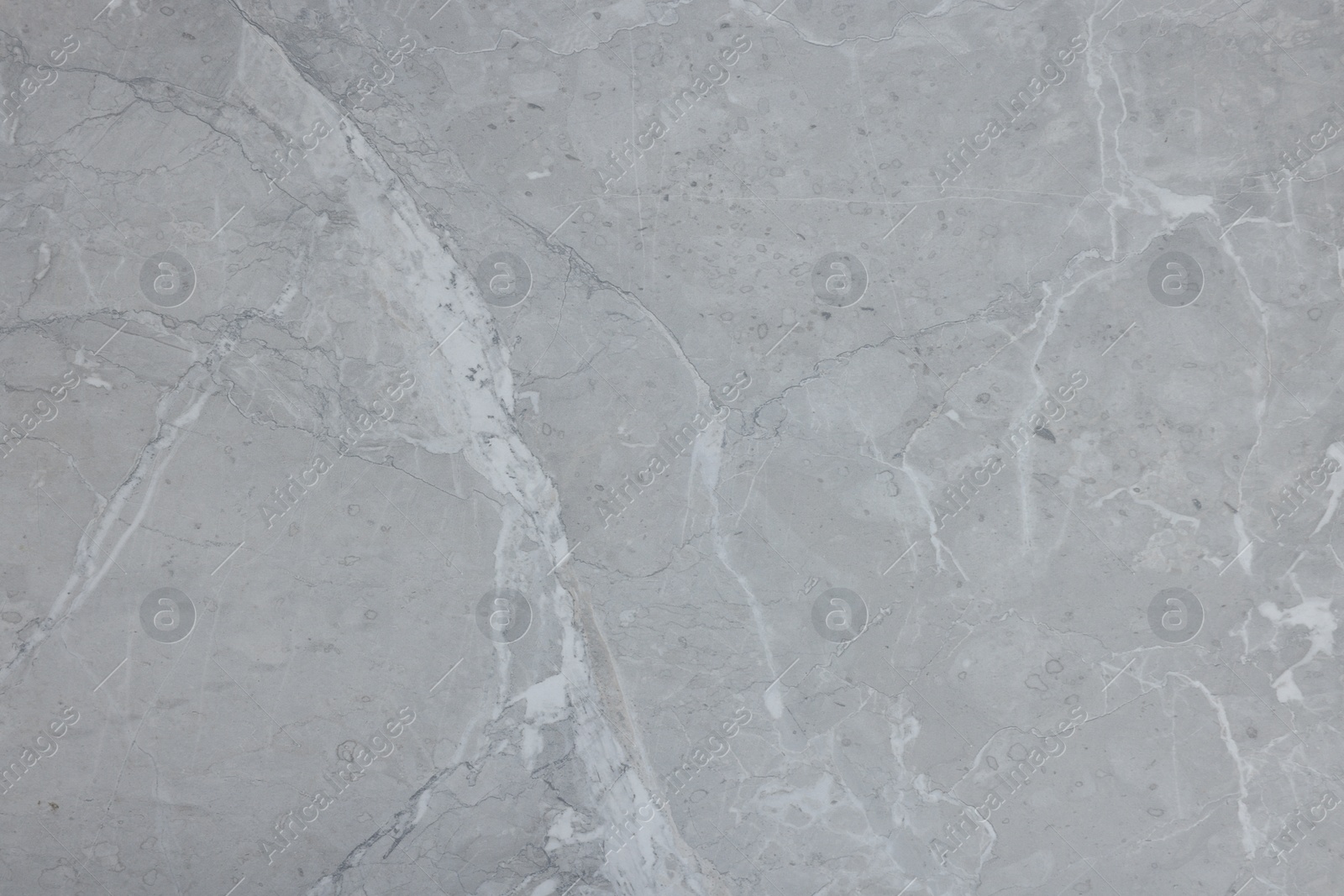 Photo of Texture of light grey marble surface as background, closeup