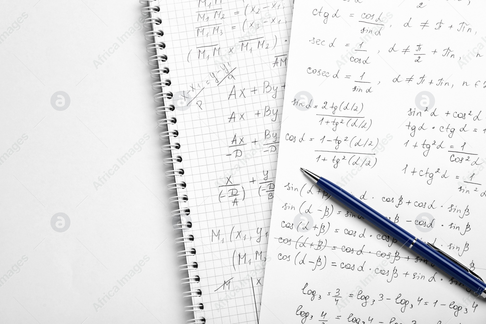 Photo of Sheets of paper with different mathematical formulas and pen on white table, top view. Space for text