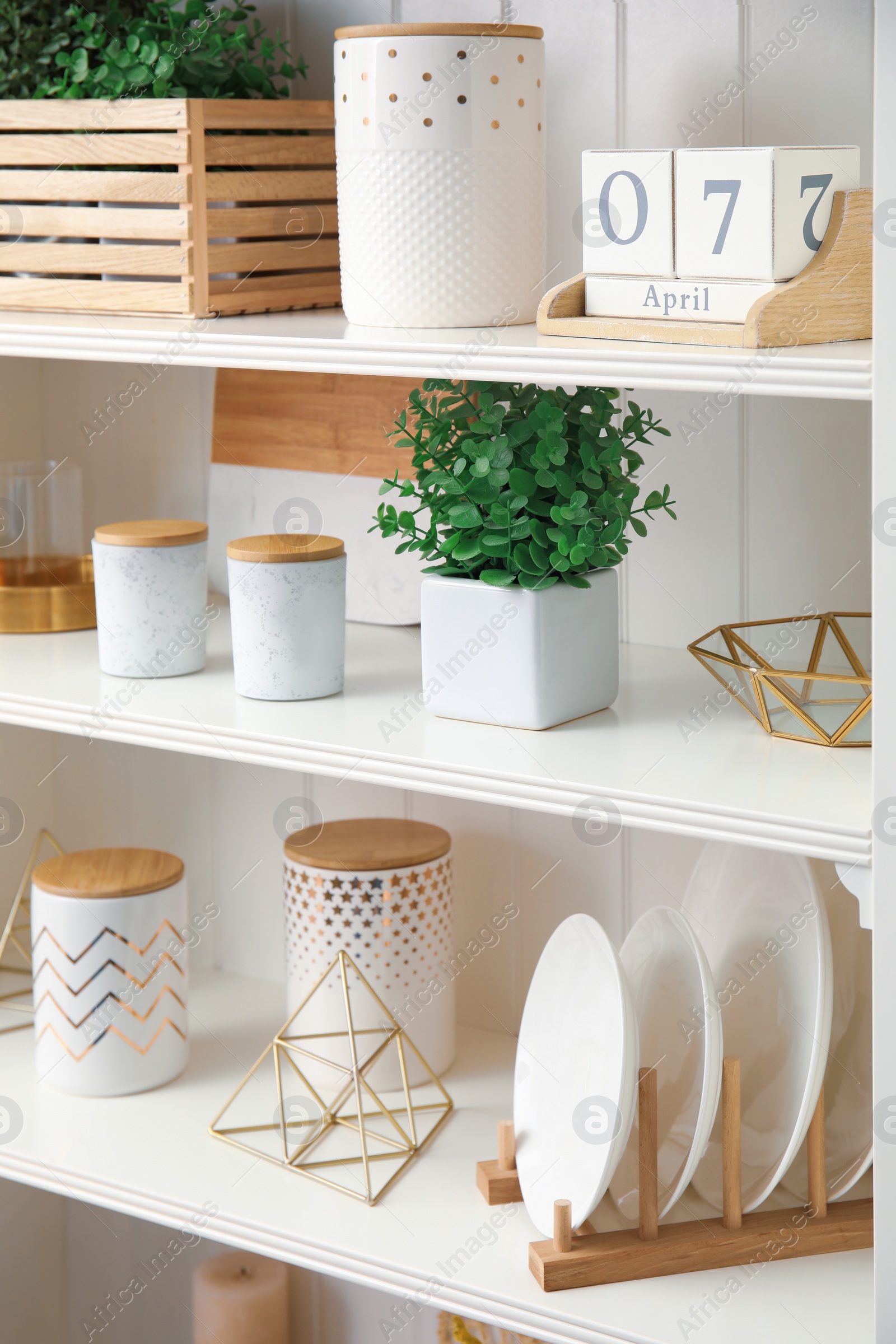 Photo of White shelving unit with dishes and different decorative stuff