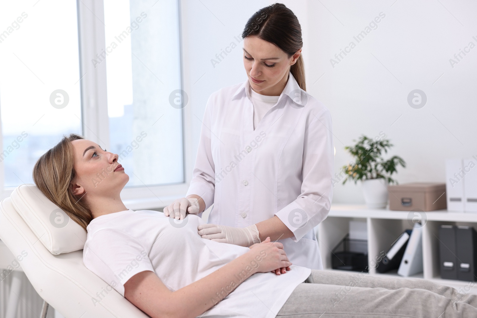 Photo of Mammologist checking young woman's breast in hospital