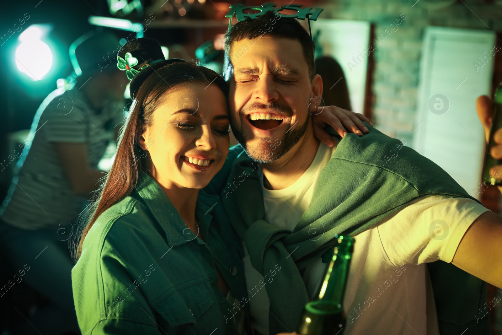 Photo of Couple with beer celebrating St Patrick's day in pub