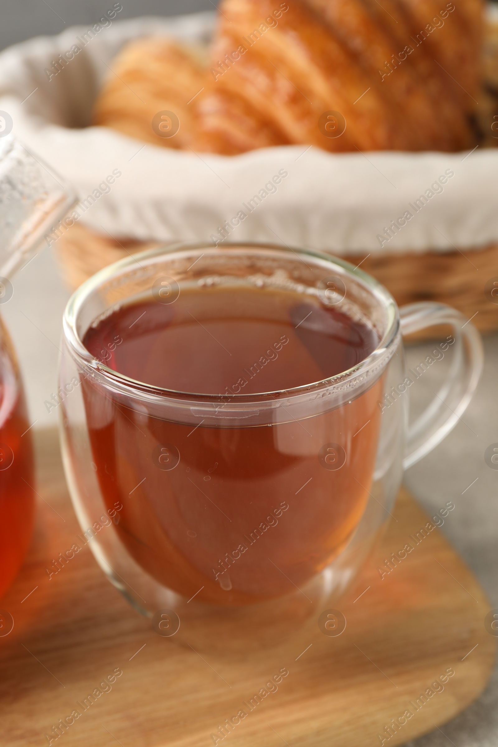 Photo of Aromatic tea in glass cup on table, closeup