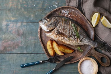 Seafood. Delicious baked fish served on wooden rustic table, flat lay with space for text