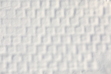 Photo of White snow with pattern as background, top view. Winter season