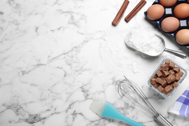 Photo of Cooking utensils and ingredients on white marble table, flat lay. Space for text