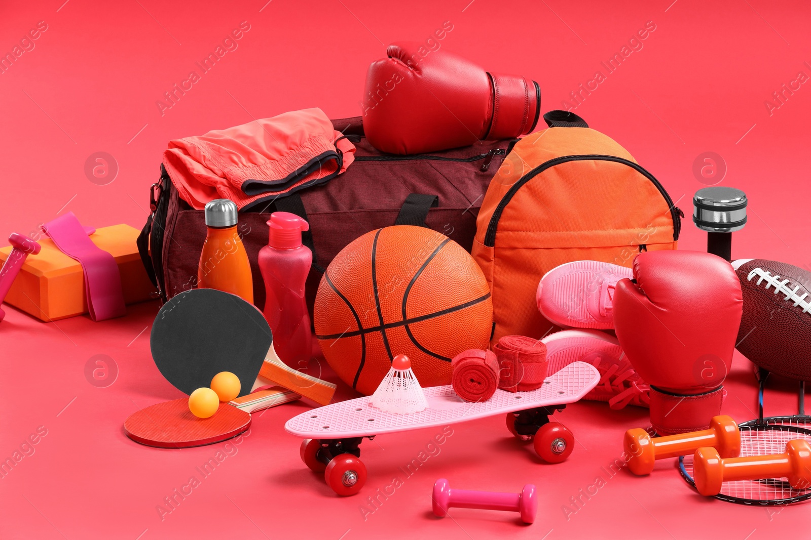 Photo of Many different sports equipment on red background