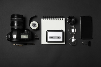Flat lay composition with equipment for journalist on black background