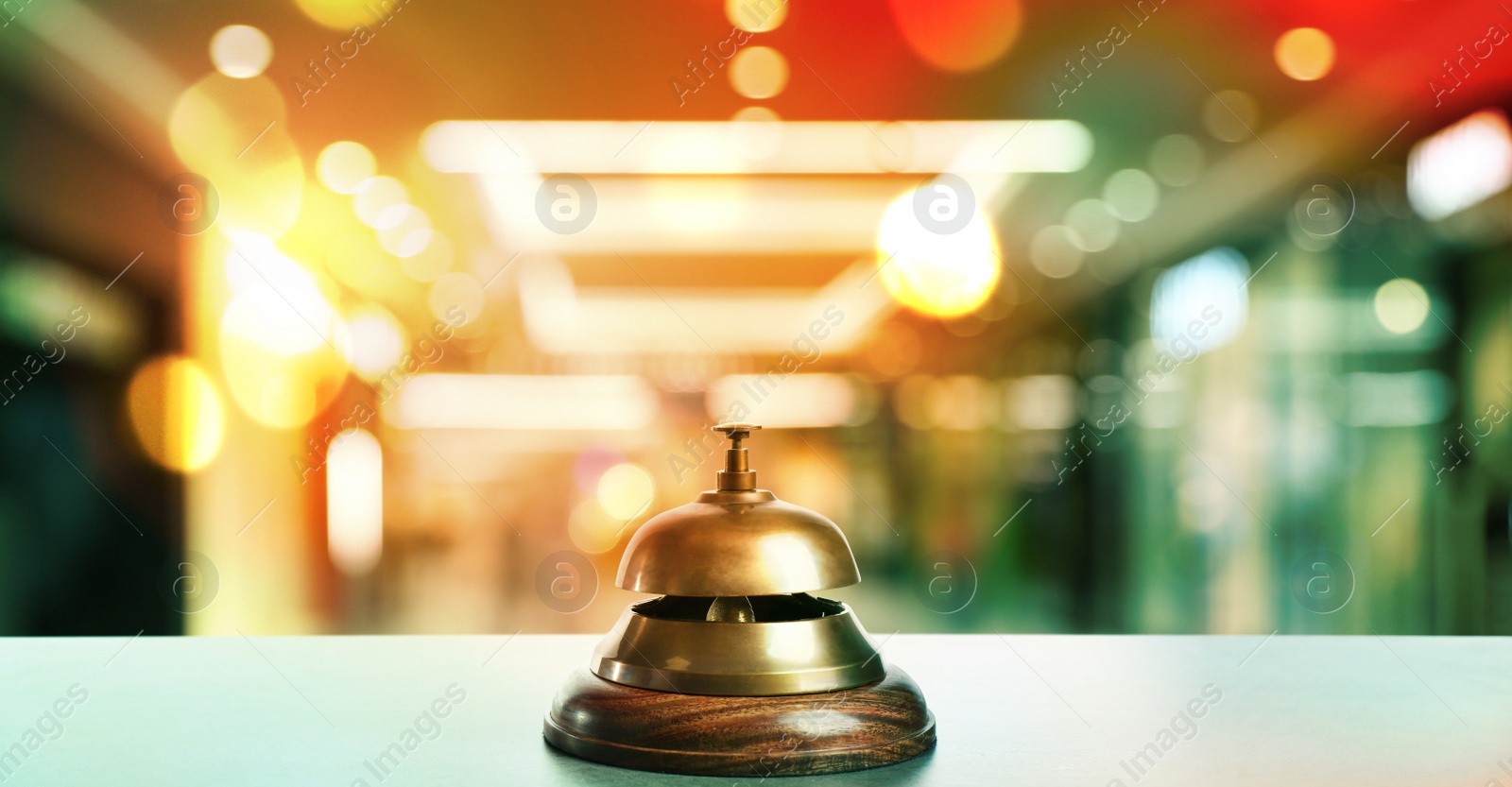 Image of Light table with hotel service bell on blurred background. Banner design